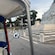 A man riding a tuk tuk by the Monument to Giuseppe Mazzini in Rome, Italy